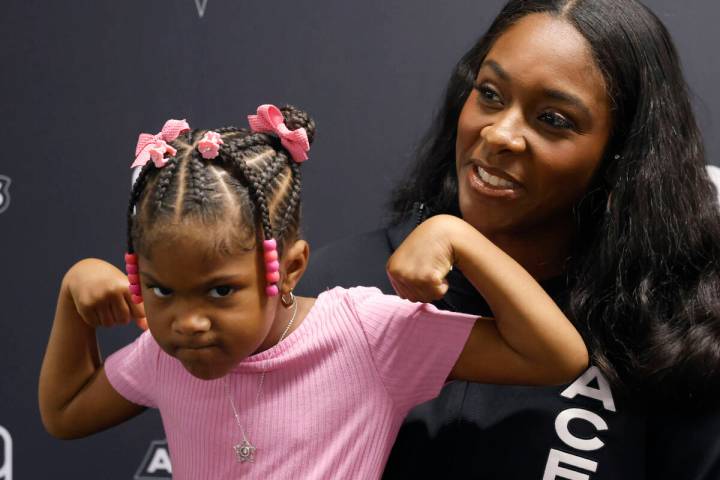 Las Vegas Aces forward Cheyenne Parker-Tyus speaks as her daughter Naomi, 3, flexes her muscles ...