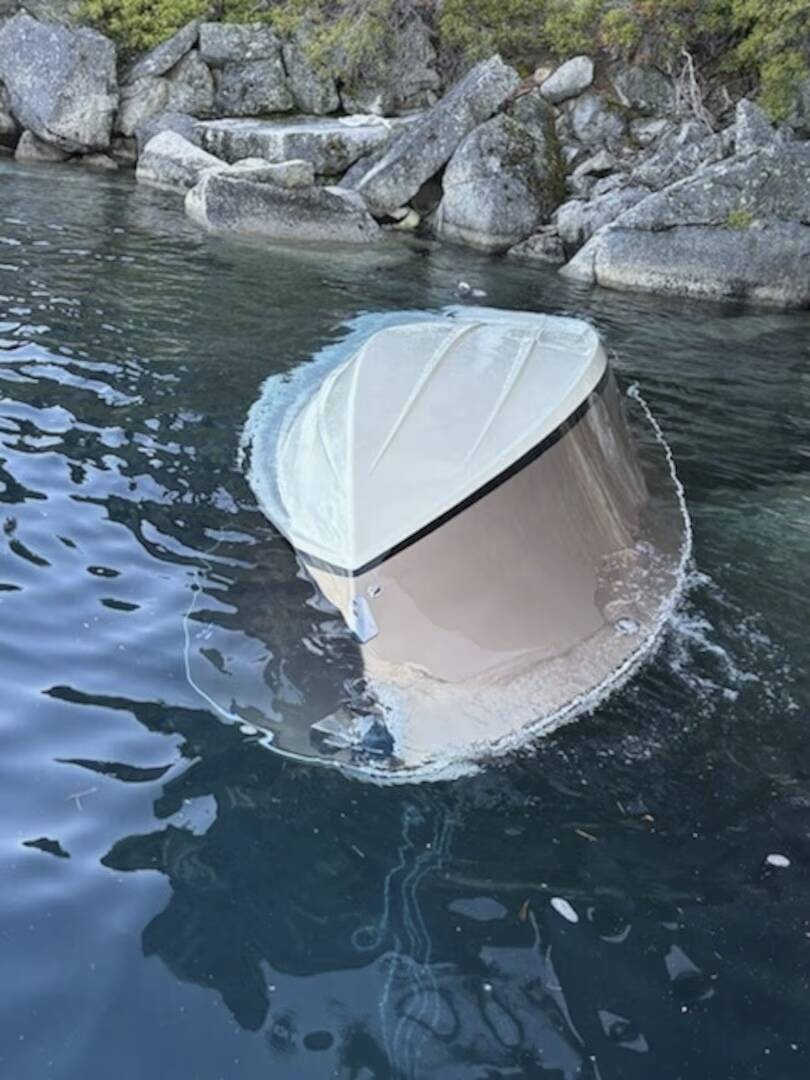 In the photo released by the U.S. Coast Guard, a capsized vessel floats is seen near D.L. Bliss ...