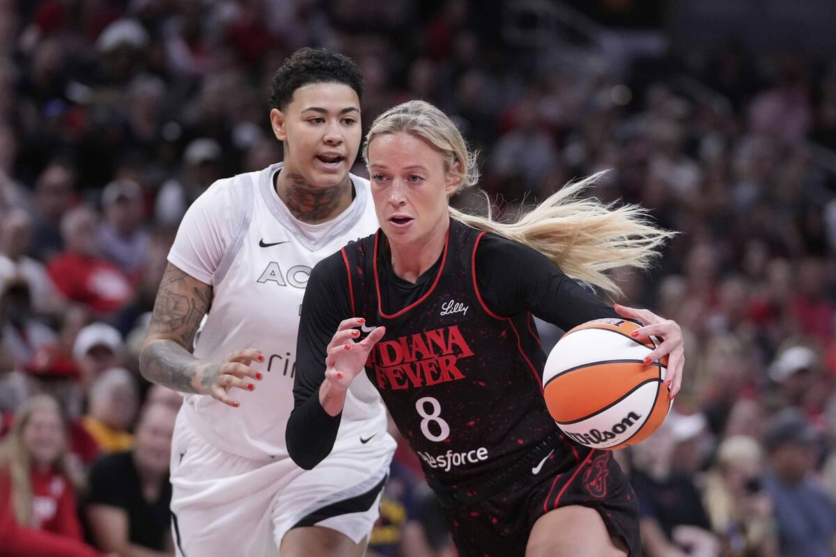 Indiana Fever's Sophie Cunningham (8) goes to the basket against Las Vegas Aces' Kierstan Bell, ...