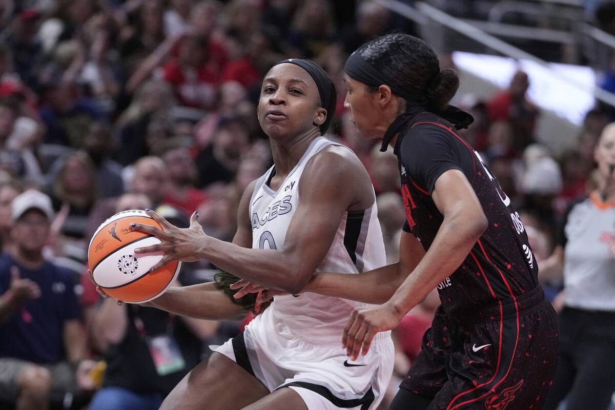 Las Vegas Aces' Jackie Young (0) goes to the basket against Indiana Fever's Sydney Colson (51) ...