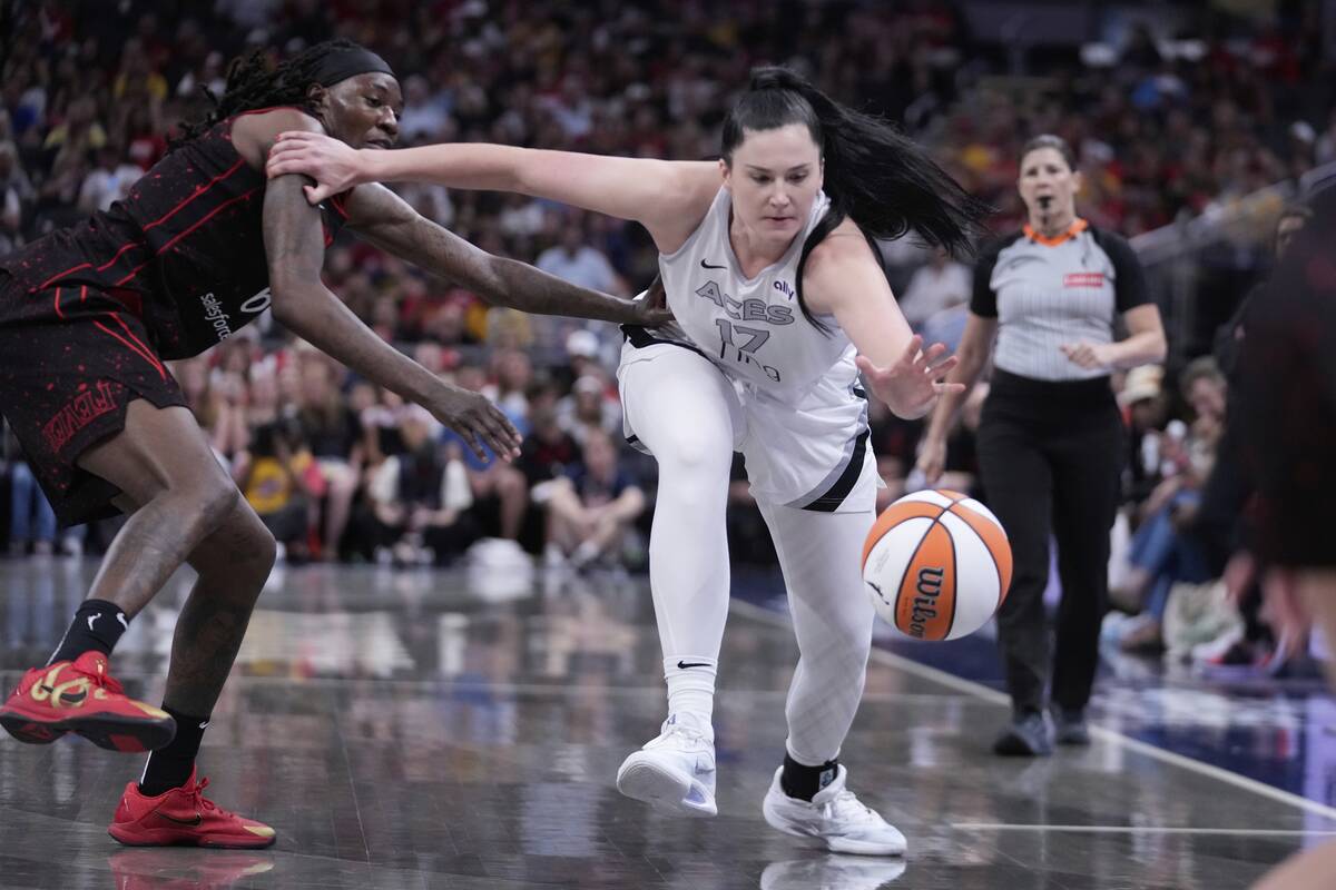 Las Vegas Aces' Megan Gustafson (17) is defended by Indiana Fever's Natasha Howard (6) during t ...