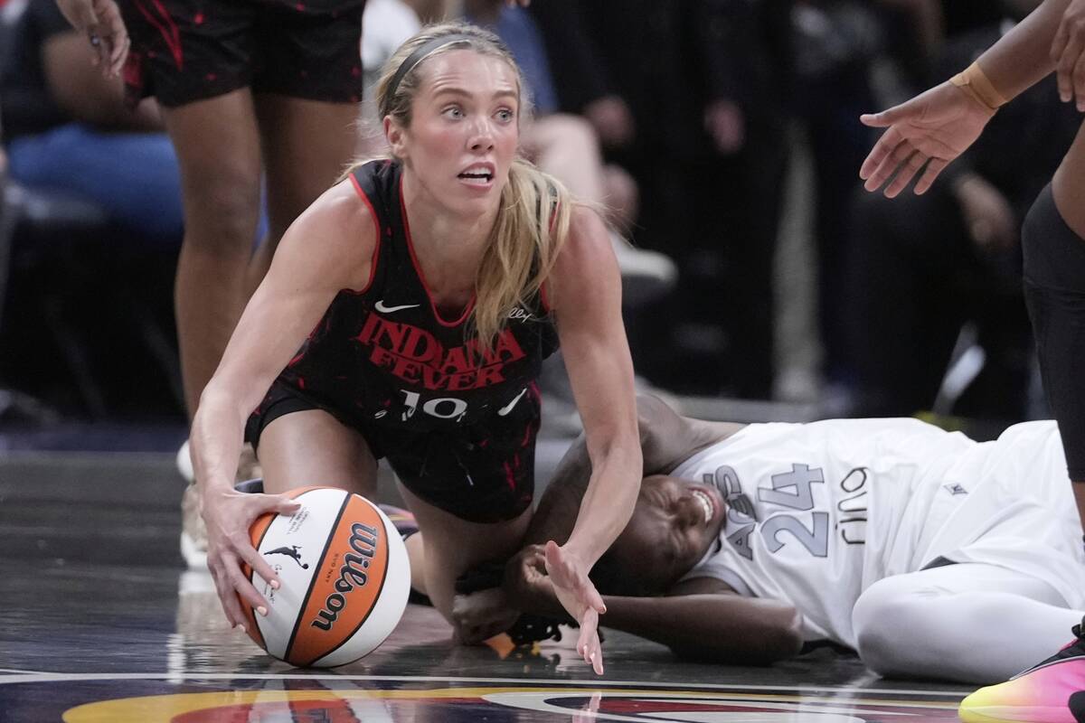 Indiana Fever's Lexie Hull (10) comes up with the ball against Las Vegas Aces' Jewell Loyd (24) ...