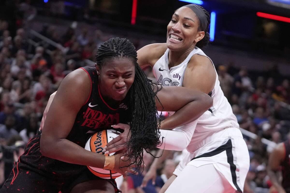 Indiana Fever's Aliyah Boston, left, is defended by Las Vegas Aces' A'ja Wilson, right, during ...