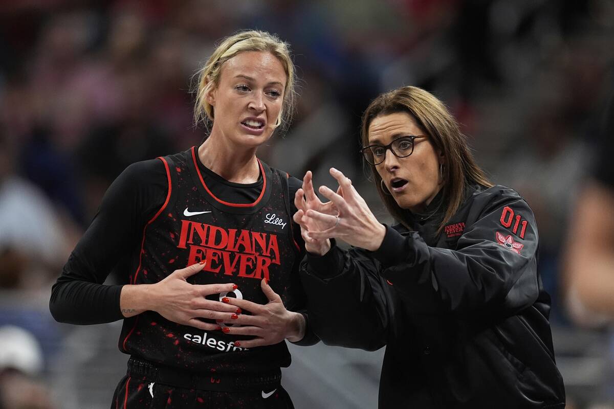 Indiana Fever head coach Stephanie White talks with Sophie Cunningham during the first half of ...
