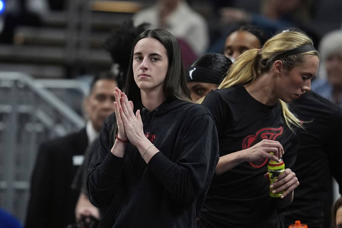 Indiana Fever's Caitlin Clark watches during the first half of a WNBA basketball game against t ...