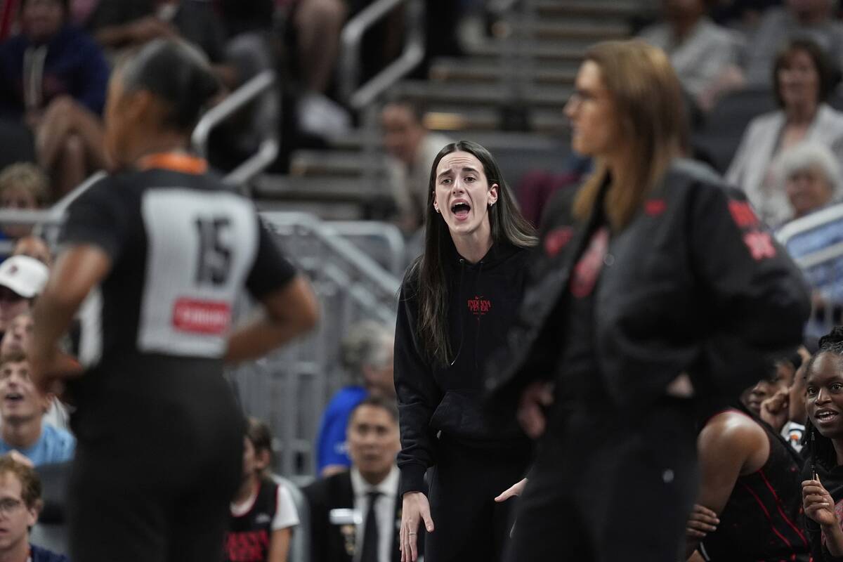 Indiana Fever's Caitlin Clark, middle, argues a call during the first half of a WNBA basketball ...