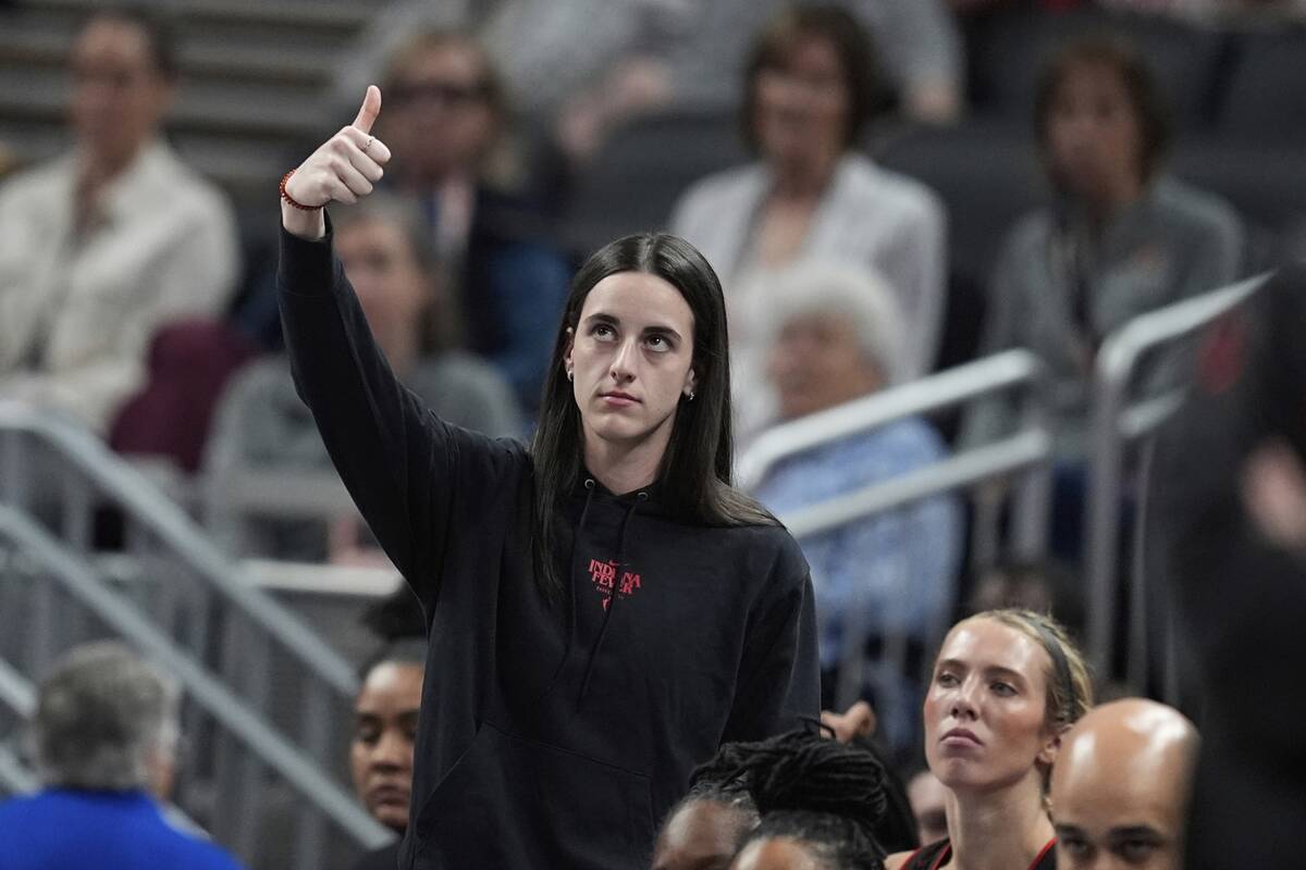 Indiana Fever's Caitlin Clark reacts on the sideline during the first half of a WNBA basketball ...