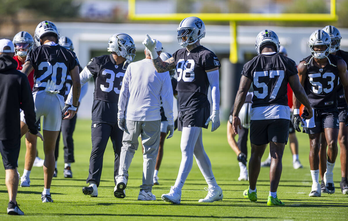 Raiders defensive end Maxx Crosby (98) signals a teammate on the second day of training camp on ...