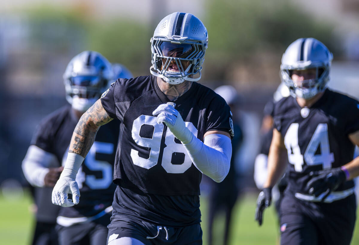 Raiders defensive end Maxx Crosby (98) warms up on the second day of training camp on Thursday, ...