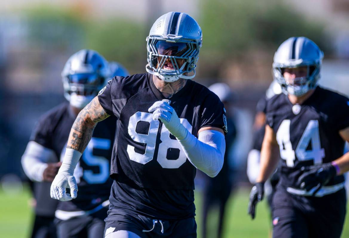 Raiders defensive end Maxx Crosby (98) warms up on the second day of training camp on Thursday, ...