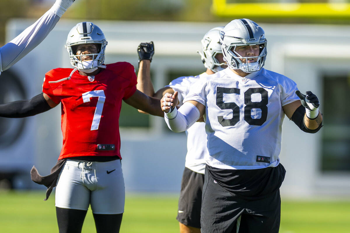 Raiders quarterback Geno Smith (7) and guard Jackson Powers-Johnson (58) warm up during the fir ...