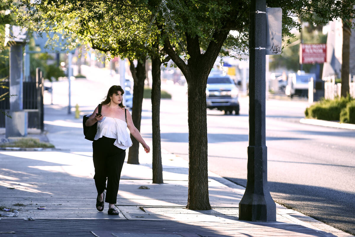 A pedestrian walks in the shade down Fremont Street Wednesday, July 23, 2025, in Las Vegas. (Sa ...