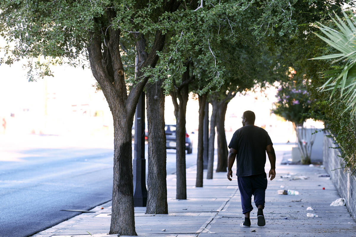 A pedestrian walks in the shade down Fremont Street Wednesday, July 23, 2025, in Las Vegas. (Sa ...
