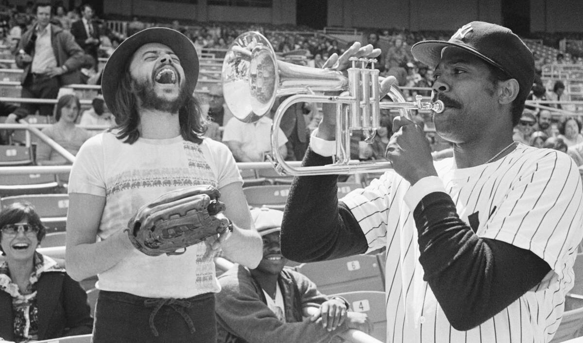 FILE - New York Yankees Pitcher Dock Ellis, right, has a little fun with a Chuck Mangione's hor ...