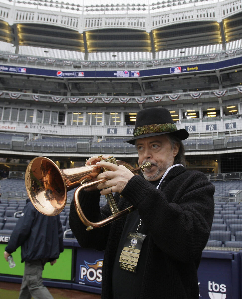 FILE - Flugelhorn player Chuck Mangione rehearses the national anthem before a baseball game be ...