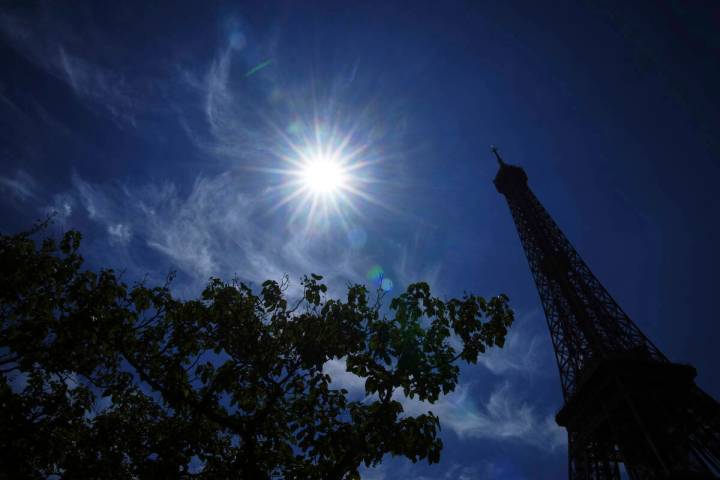 The sun shines over the the Eiffel Tower during a heat wave, Monday, June 30, 2025 in Paris. (A ...