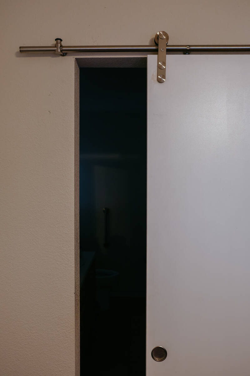 A barn door in Michael Chapman’s home leads to his bathroom on Thursday, July 24, 2025 in Las ...