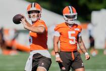 Cleveland Browns quarterback Joe Flacco, left, throws in front of quarterback Dillon Gabriel (5 ...