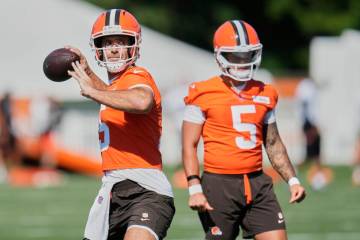 Cleveland Browns quarterback Joe Flacco, left, throws in front of quarterback Dillon Gabriel (5 ...