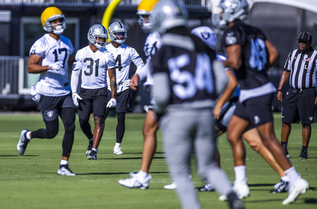 Raiders running back Raheem Mostert (31) joins in a punt drill with teammates during the third ...