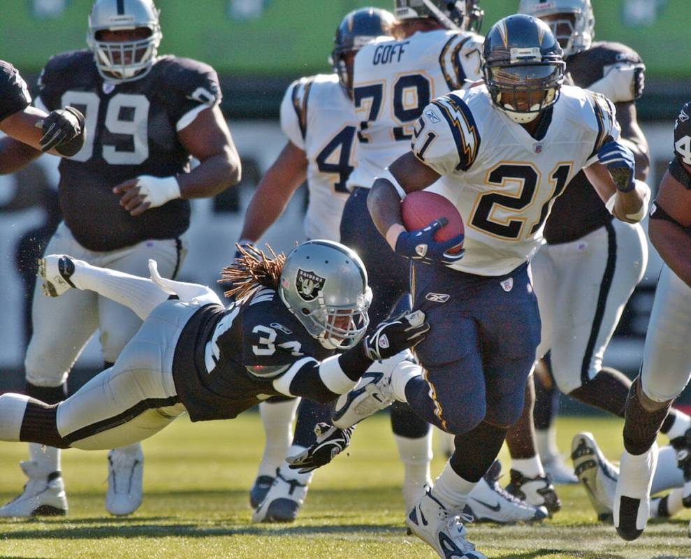 San Diego Chargers running back LaDainian Tomlinson rushes past Oakland Raiders safety Ray Buch ...