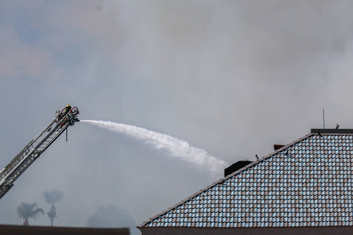 Firefighters battle a fire on Maryland Parkway near the UNLV campus on Friday, July 25, 2025 in ...
