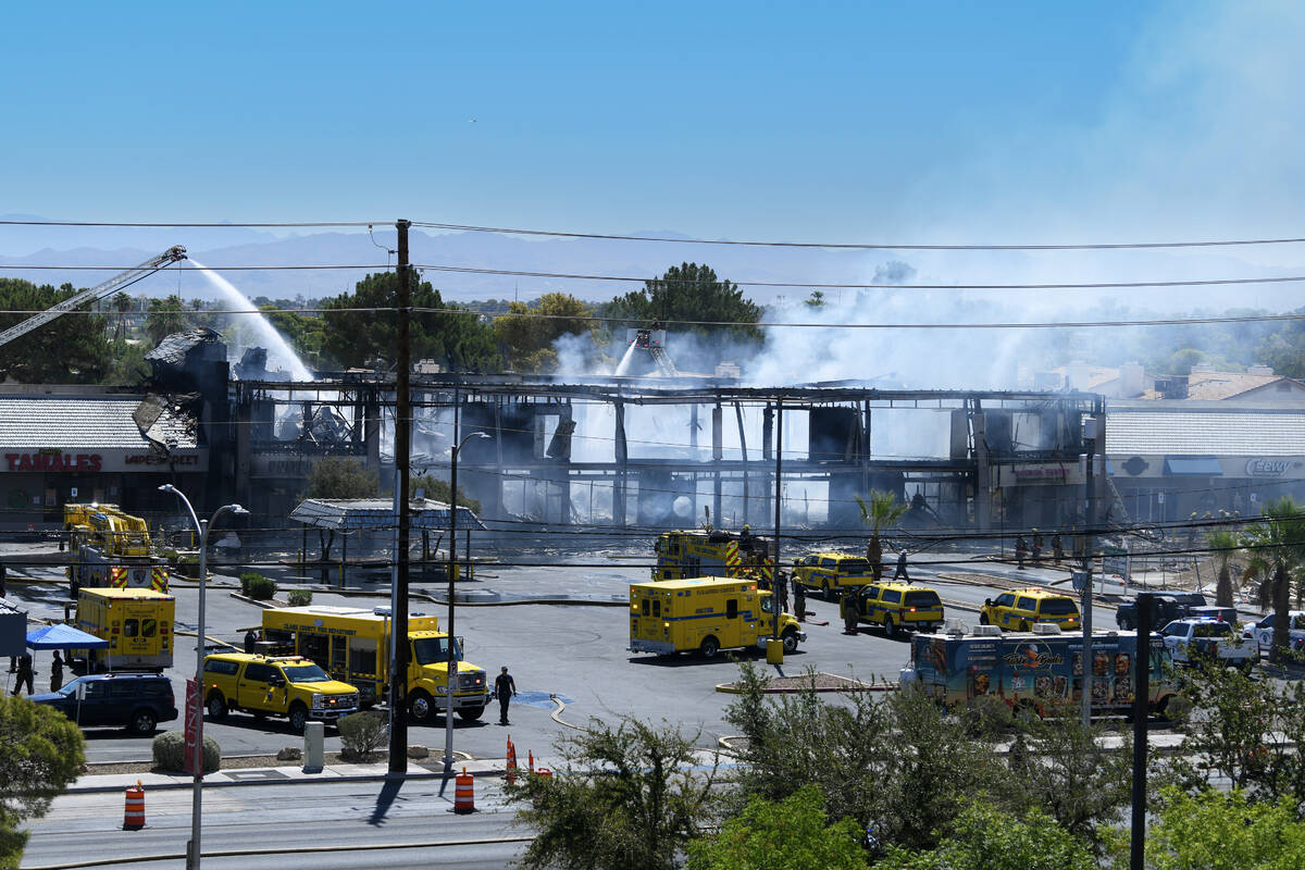 Firefighters finish putting out a three-alarm building fire on the 4600 block of Maryland Parkw ...