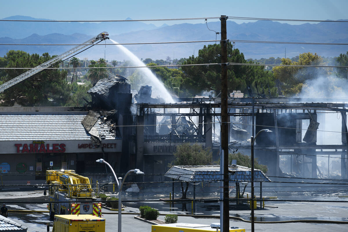 Firefighters finish putting out a three-alarm building fire on the 4600 block of Maryland Parkw ...