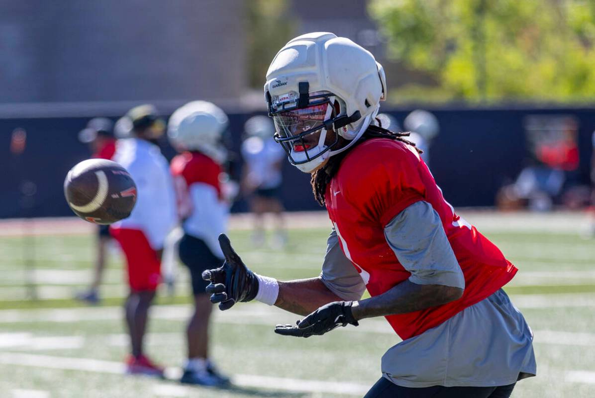 UNLV wide receiver Troy Omeire (0) looks in a pass during football practice at the Fertitta Foo ...