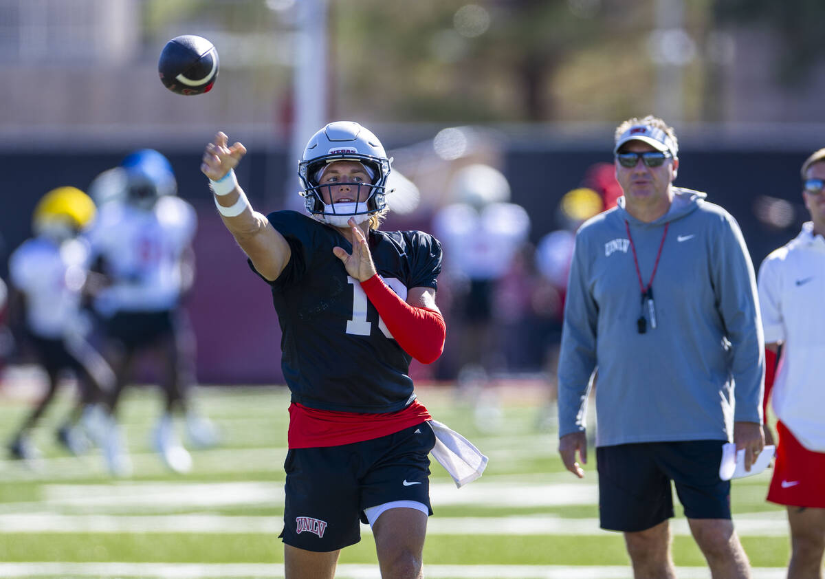 UNLV quarterback Anthony Colandrea (10) gets off a pass as head coach Dan Mullen looks on durin ...