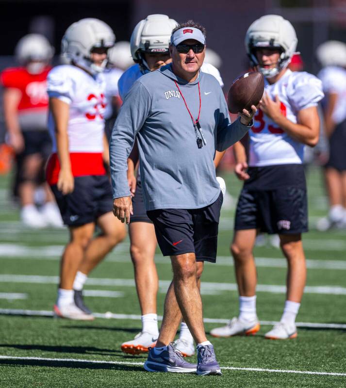 UNLV head coach Dan Mullen observes a play during football practice at the Fertitta Football Co ...