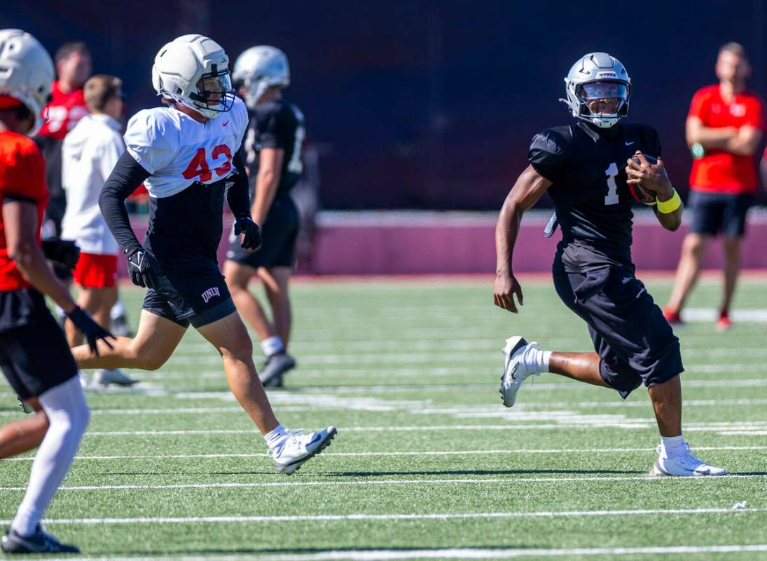 UNLV quarterback Alex Orji (1) looks for more yards on the outside on a run during football pra ...