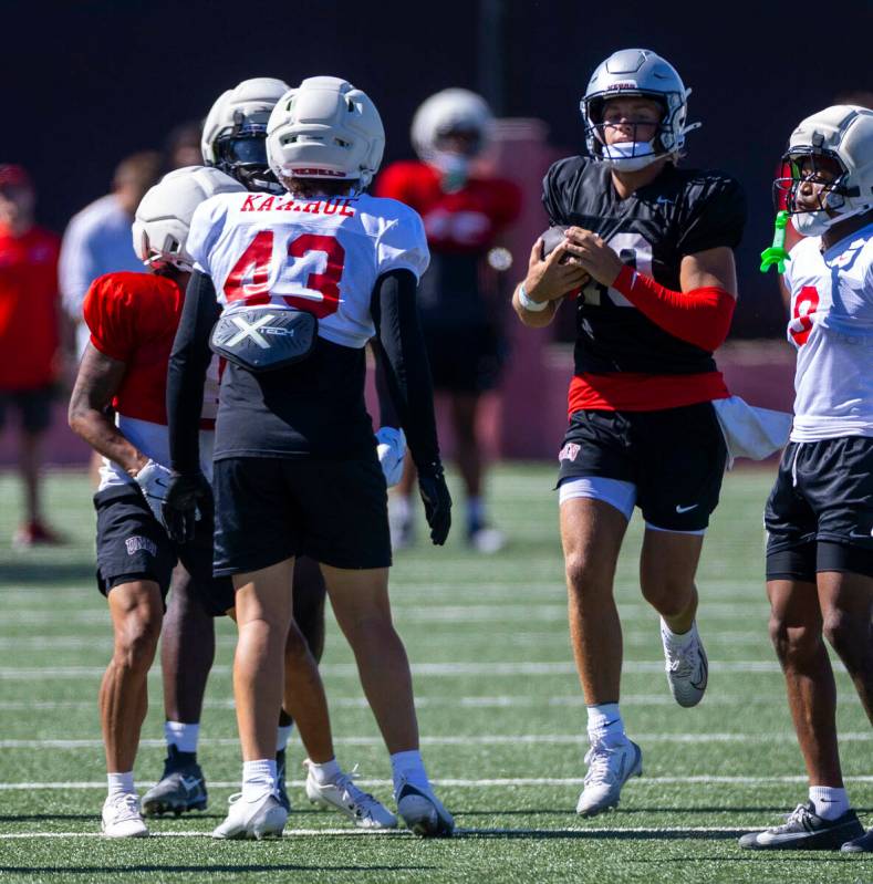 UNLV quarterback Anthony Colandrea (10) eases through the line on a run during football practic ...