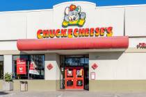 Wearing the furry mask of the iconic Chuck E. Cheese mascot mouse, an employee of the popular c ...