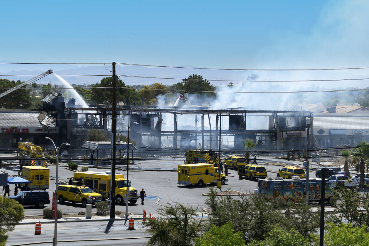 Firefighters finish putting out a three-alarm building fire on the 4600 block of Maryland Parkw ...
