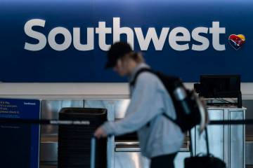 A traveler walks through the Southwest Airlines ticketing counter area at the Los Angeles Inter ...