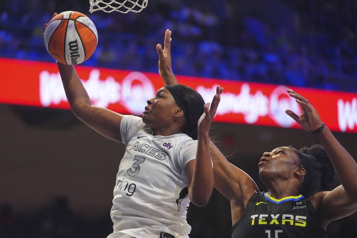 Las Vegas Aces forward NaLyssa Smith (3) drives to the basket against Dallas Wings center Teair ...