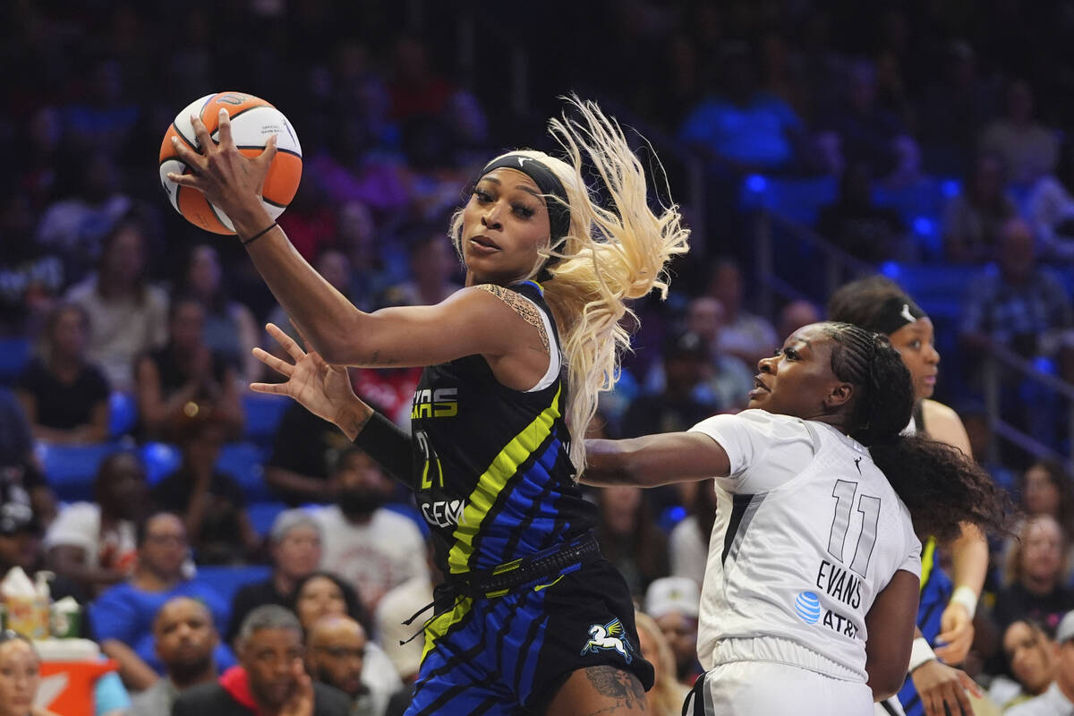 Dallas Wings guard DiJonai Carrington (21) moves against Las Vegas Aces guard Dana Evans (11) d ...