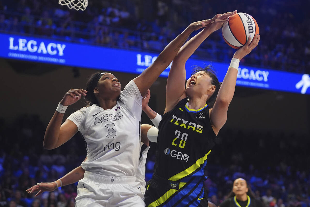 Las Vegas Aces forward NaLyssa Smith (3) defends the basket against Dallas Wings center Li Yuer ...