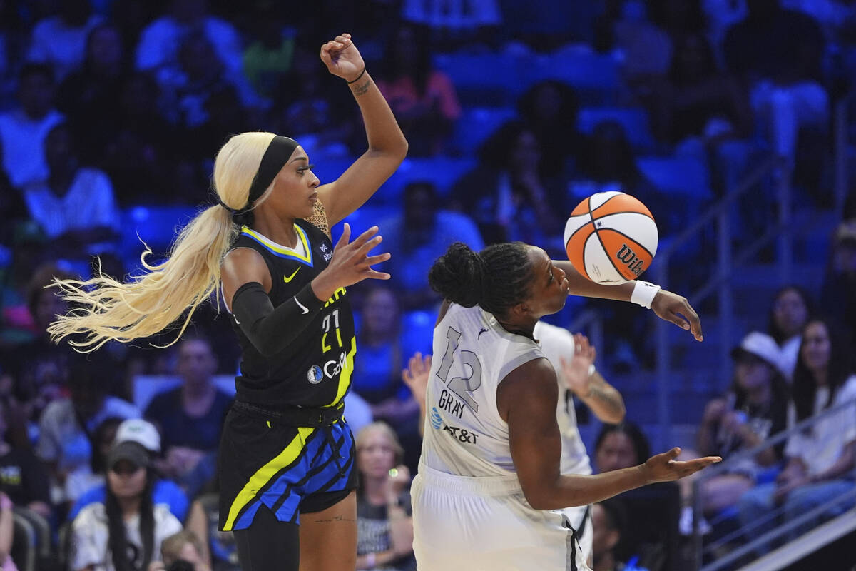 Las Vegas Aces guard Chelsea Gray (12) and Dallas Wings guard DiJonai Carrington (21) vie for c ...