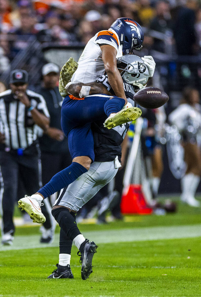 Raiders cornerback Decamerion Richardson (25) breaks up a pass for Denver Broncos wide receiver ...