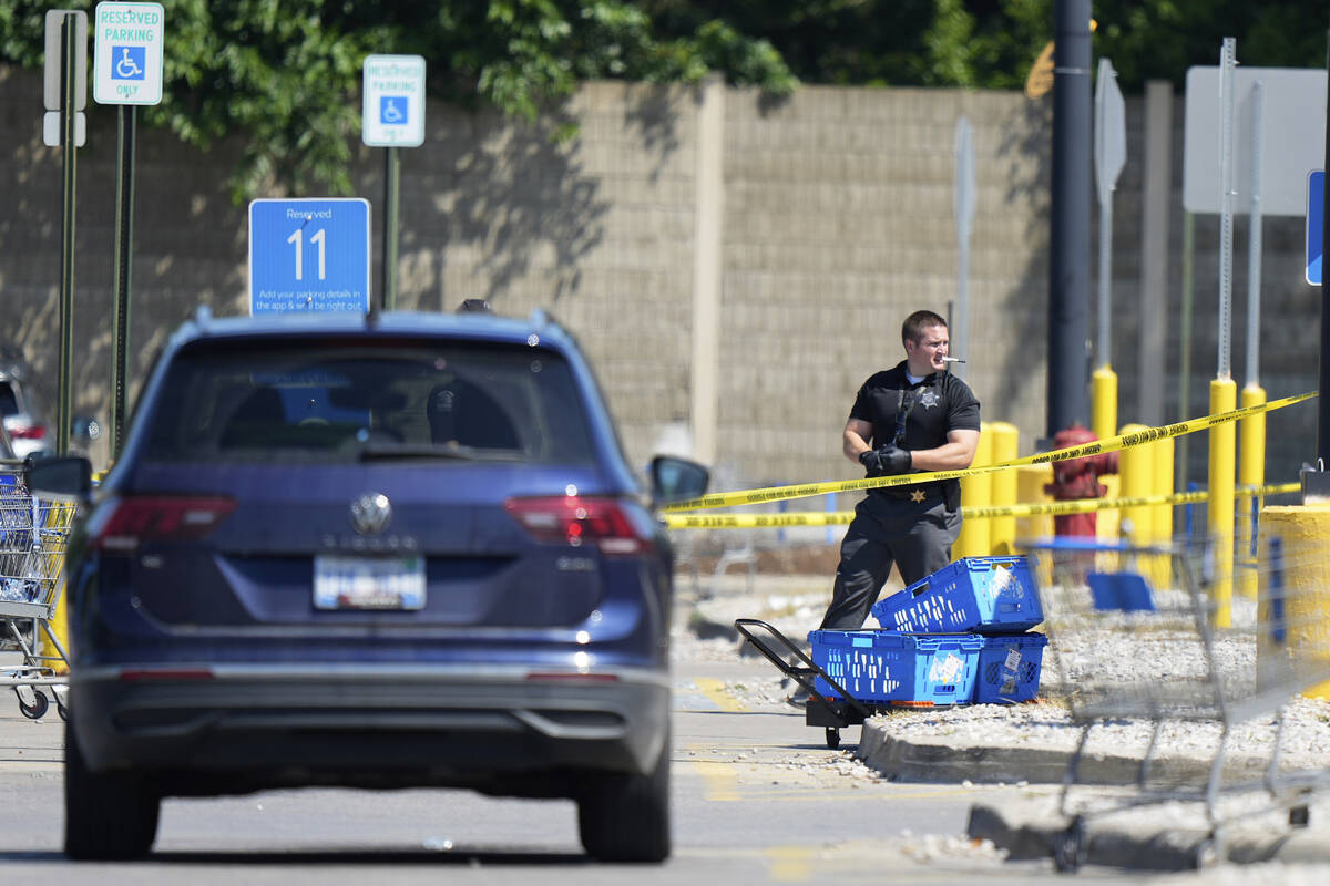 Law enforcement officers investigate outside of a Walmart, Sunday, July 27, 2025, where a multi ...