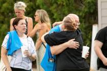 Walmart employees and customers wait outside while law enforcement investigates the scene after ...