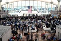 Passengers wait in a security line at Denver International Airport on Feb. 22, 2023. (AP Photo/ ...