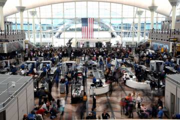 Passengers wait in a security line at Denver International Airport on Feb. 22, 2023. (AP Photo/ ...