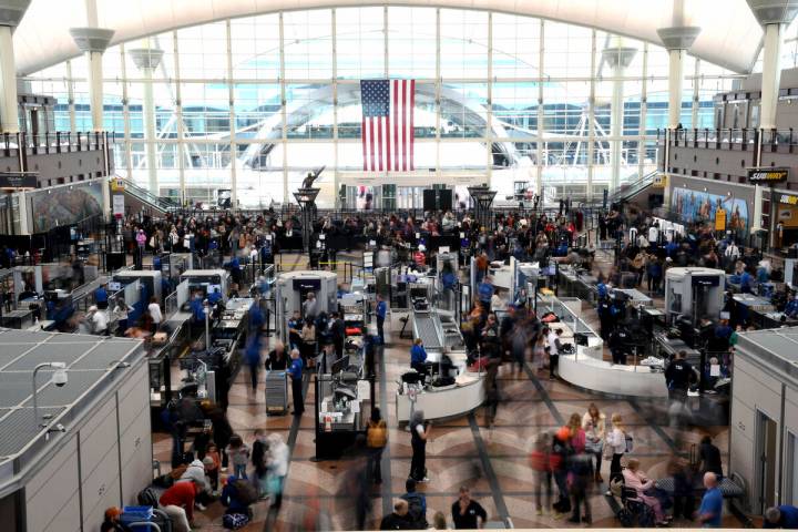 Passengers wait in a security line at Denver International Airport on Feb. 22, 2023. (AP Photo/ ...