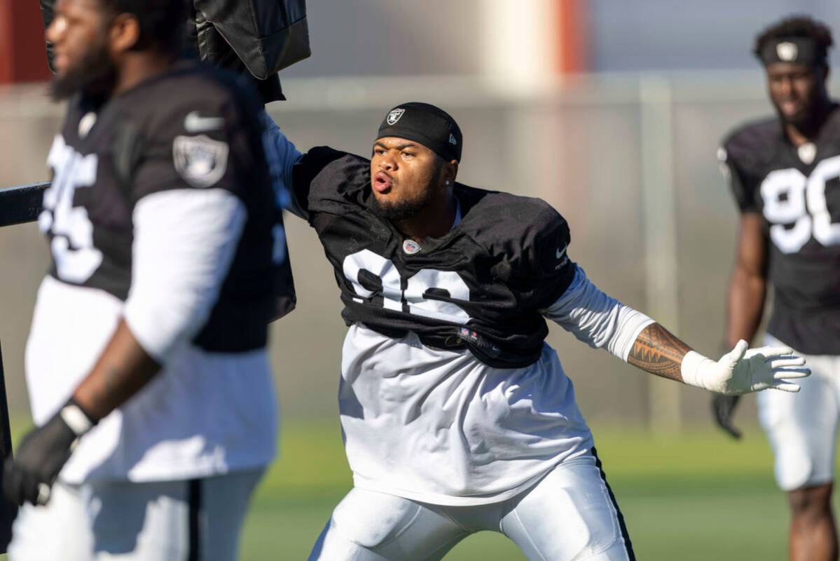 Raiders defensive tackle Jonah Laulu (96) works against a tackle post during the team’s ...