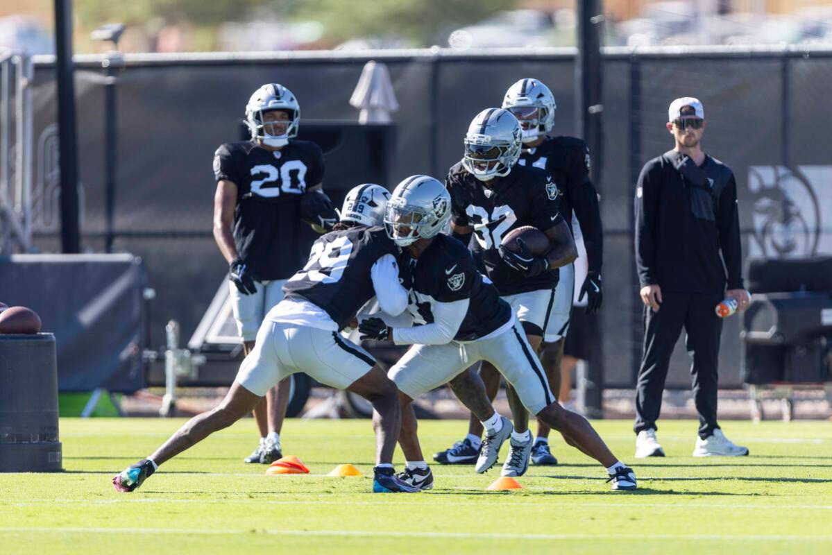 Raiders safety Chris Smith II (29) and safety Trey Taylor (37) work against each other in a dri ...