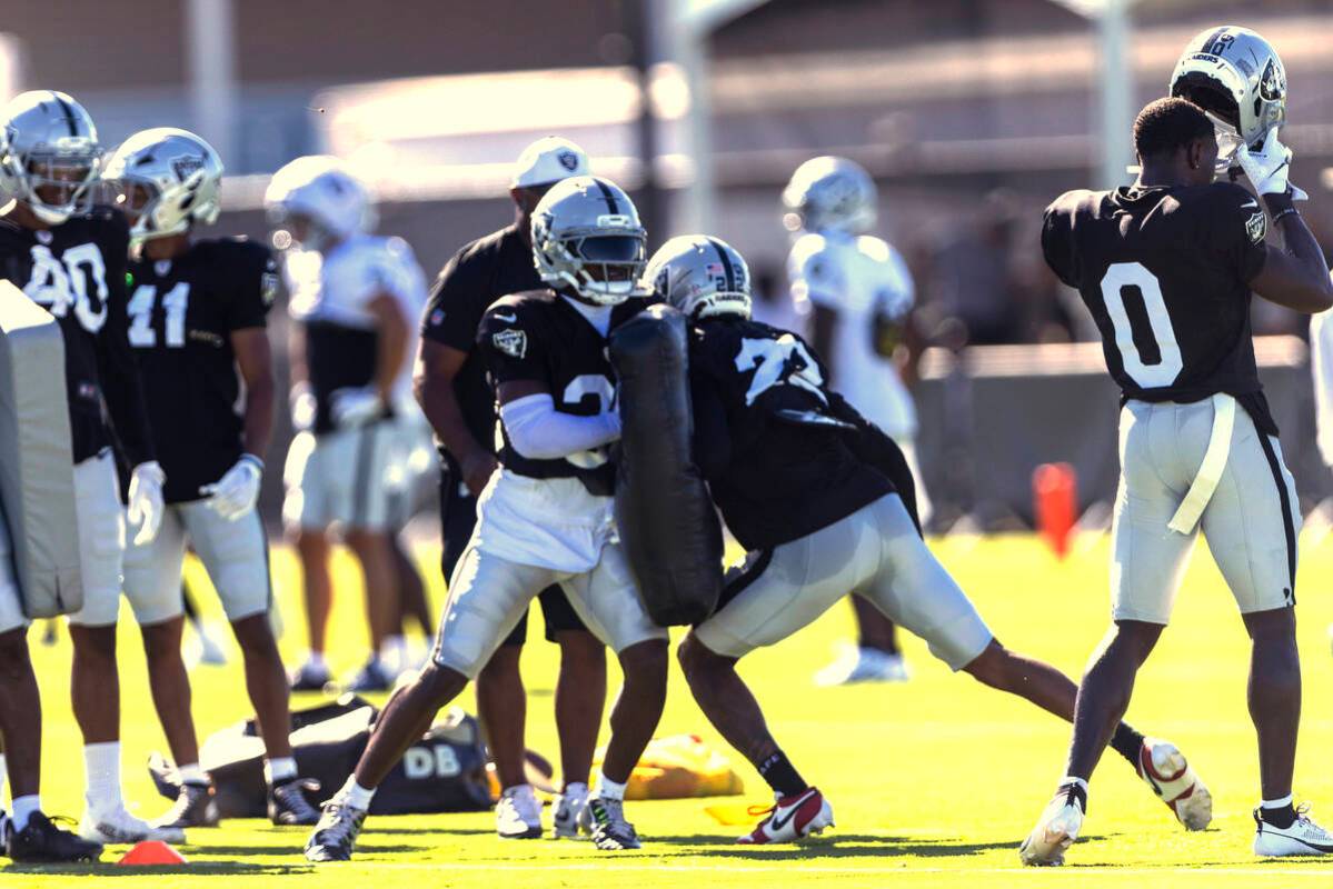 Raiders safety Chris Smith II (29) holds pads as cornerback Eric Stokes (22) works against him ...