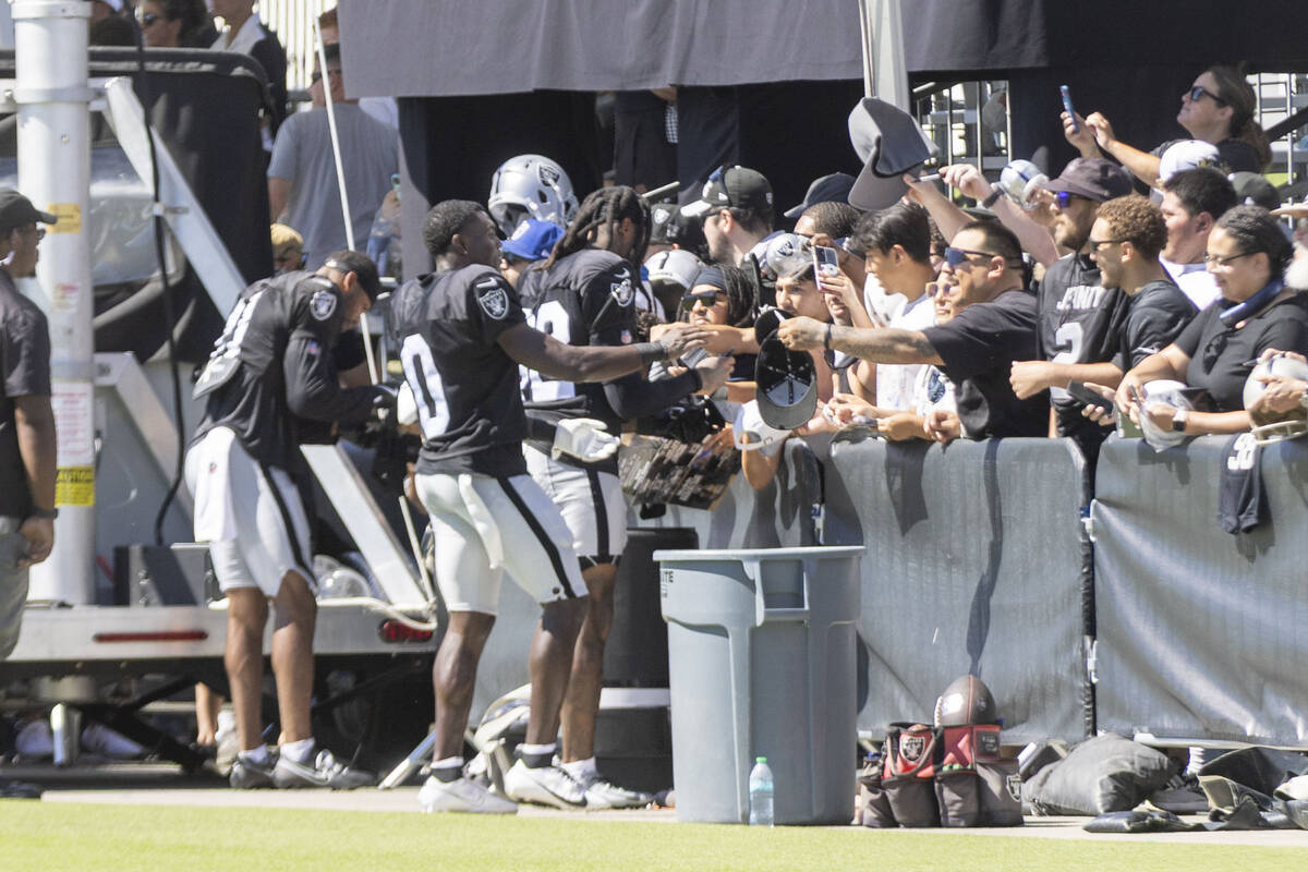 Raiders cornerback Jakorian Bennett (0) meets with fans during the team’s training camp ...